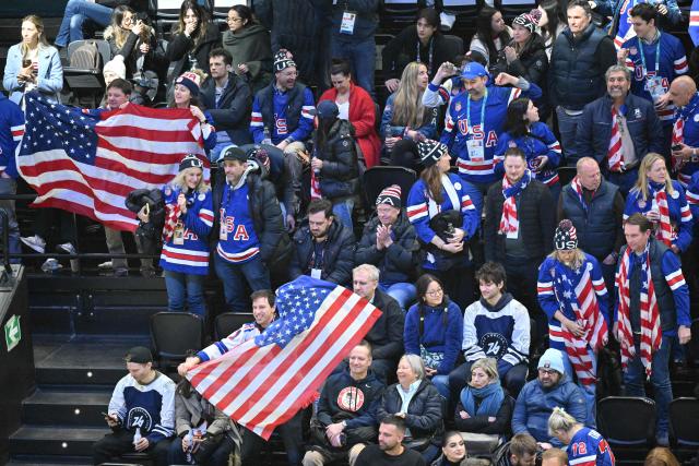 USA supporters cheer their team  during the men's play-off semi-final ice hockey match between USA and Slovakia at the Milano Santagiulia Ice Hockey Arena during the Milano Cortina 2026 Winter Olympic Games in Milan, on February 20, 2026. (Photo by Antonin THUILLIER / AFP)