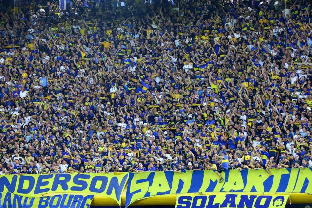 Boca Juniors’ fans cheer for their team during the Argentine Professional Football League 2026 Apertura Tournament match between Boca Juniors and Racing at La Bombonera Stadium in Buenos Aires on February 20, 2026. (Photo by Alejandro PAGNI / AFP)