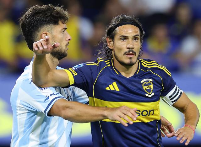 Racing's defender #03 Marco Di Cesare and Boca Juniors' Uruguayan forward #10 Edinson Cavani eye on the ball during the Argentine Professional Football League 2026 Apertura Tournament match between Boca Juniors and Racing at La Bombonera Stadium in Buenos Aires on February 20, 2026. (Photo by Alejandro PAGNI / AFP)