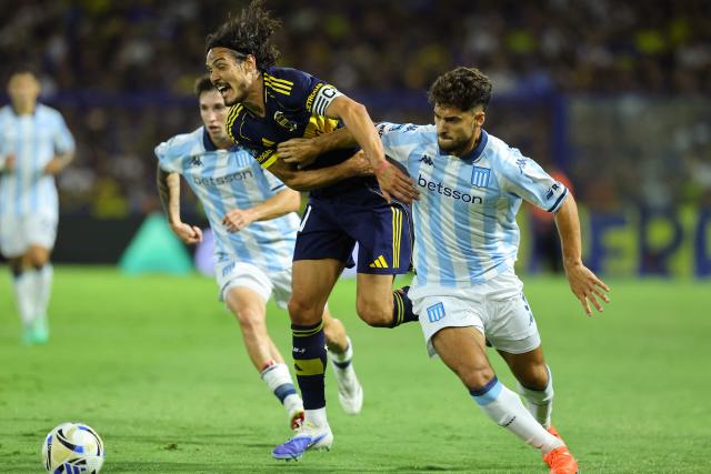 Boca Juniors' Uruguayan forward #10 Edinson Cavani and Racing's defender #03 Marco Di Cesare fight for the ball during the Argentine Professional Football League 2026 Apertura Tournament match between Boca Juniors and Racing at La Bombonera Stadium in Buenos Aires on February 20, 2026. (Photo by Alejandro PAGNI / AFP)