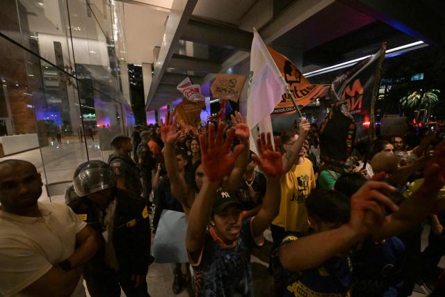 Brazilian natives from the Guarani ethnic group and environmental activists protest against dredging in the Amazon in front of the headquarters of US agribusiness giant Cargill in Sao Paulo, Brazil, on February 20, 2026. (Photo by NELSON ALMEIDA / AFP)
