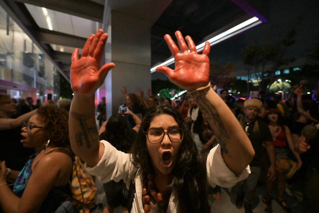 Brazilian natives from the Guarani ethnic group and environmental activists protest against dredging in the Amazon in front of the headquarters of US agribusiness giant Cargill in Sao Paulo, Brazil, on February 20, 2026. (Photo by NELSON ALMEIDA / AFP)