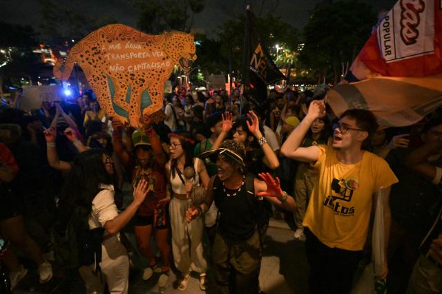 Brazilian natives from the Guarani ethnic group and environmental activists protest against dredging in the Amazon in front of the headquarters of US agribusiness giant Cargill in Sao Paulo, Brazil, on February 20, 2026. (Photo by NELSON ALMEIDA / AFP)