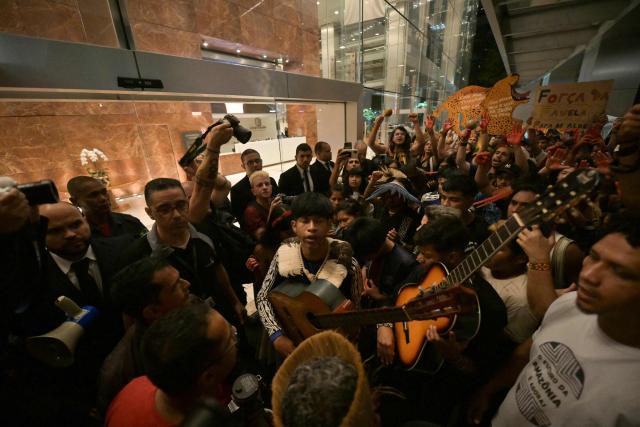 Brazilian natives from the Guarani ethnic group and environmental activists protest against dredging in the Amazon in front of the headquarters of US agribusiness giant Cargill in Sao Paulo, Brazil, on February 20, 2026. (Photo by NELSON ALMEIDA / AFP)