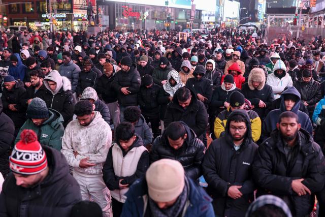 Members of the Muslim community take part in a Taraweeh prayer during Ramadan in Times Square on February 20, 2026 in New York City. (Photo by ANGELA WEISS / AFP)