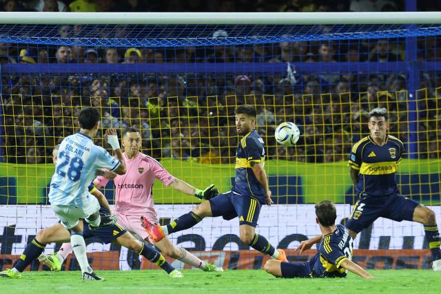 Racing's forward #28 Santiago Solari (L) shoots and fails against Boca Juniors' goalkeeper #01 Agustin Marchesin during the Argentine Professional Football League 2026 Apertura Tournament match between Boca Juniors and Racing at La Bombonera Stadium in Buenos Aires on February 20, 2026. (Photo by ALEJANDRO PAGNI / AFP)