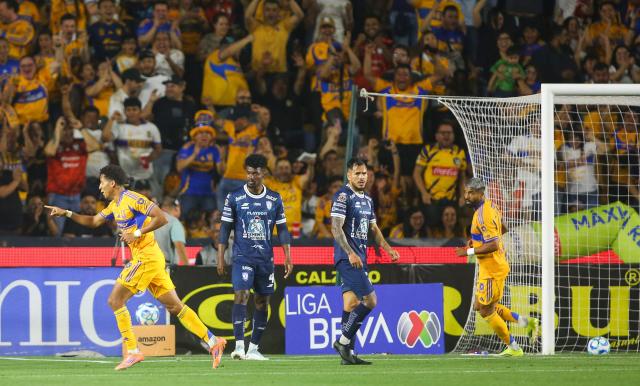 Tigres' forward #77 Ozziel Herrera (L) celebrates after scoring his team's first goal during the Liga MX Clausura football match between Tigres and Pachuca at the University Stadium (UANL) in Monterrey, Mexico, on February 20, 2026. (Photo by Julio Cesar AGUILAR / AFP)