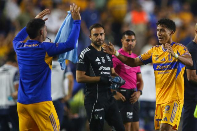 Tigres' forward #77 Ozziel Herrera (R) celebrates with teammates after scoring his team's first goal during the Liga MX Clausura football match between Tigres and Pachuca at the University Stadium (UANL) in Monterrey, Mexico, on February 20, 2026. (Photo by Julio Cesar AGUILAR / AFP)