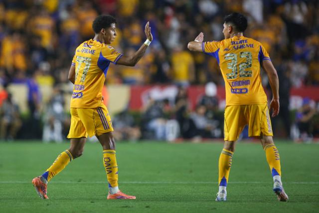 Tigres' forward #77 Ozziel Herrera (L) celebrates with teammate defender #32 Vladimir Lorona after scoring his team's first goal during the Liga MX Clausura football match between Tigres and Pachuca at the University Stadium (UANL) in Monterrey, Mexico, on February 20, 2026. (Photo by Julio Cesar AGUILAR / AFP)