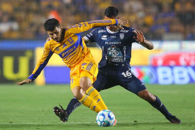 Tigres' Argentine forward #07 Angel Correa (L) and Pachuca's Colombian midfielder #16 Christian Rivera fight for the ball during the Liga MX Clausura football match between Tigres and Pachuca at the University Stadium (UANL) in Monterrey, Mexico, on February 20, 2026. (Photo by Julio Cesar AGUILAR / AFP)