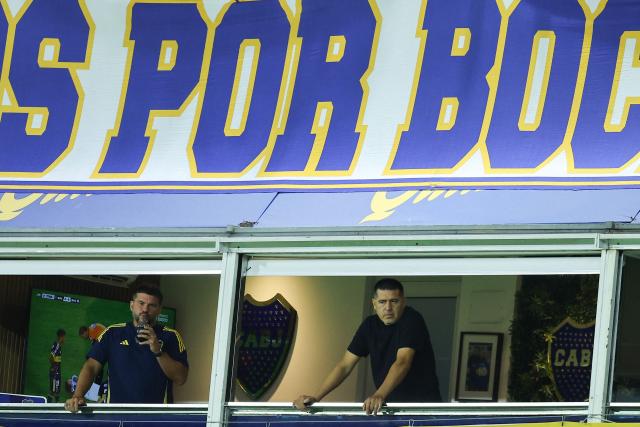 Boca Juniors’ president Juan Roman Riquelme (R) watches form the stands during the Argentine Professional Football League 2026 Apertura Tournament match between Boca Juniors and Racing at La Bombonera Stadium in Buenos Aires on February 20, 2026. (Photo by Alejandro PAGNI / AFP)