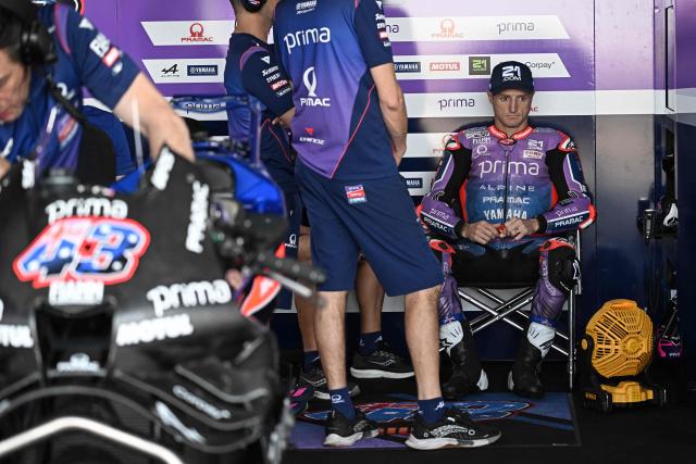 Prima Pramac Yamaha's Austrialian rider Jack Miller (R) sits in the garage during the first day of the 2026 MotoGP pre-season test at the Buriram International Circuit in Buriram on February 21, 2026. (Photo by Lillian SUWANRUMPHA / AFP)