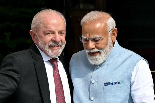 India's Prime Minister Narendra Modi (R) and Brazil's President Luiz Inacio Lula da Silva walk before their meeting at the Hyderabad House in New Delhi on February 21, 2026. (Photo by Sajjad HUSSAIN / AFP)