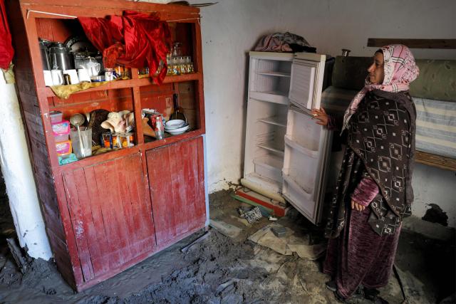 A woman inspects damage in one of the houses affected by floods that struck northern and western Morocco, in the Kenitra region on February 20, 2026. (Photo by Abdel Majid BZIOUAT / AFP)
