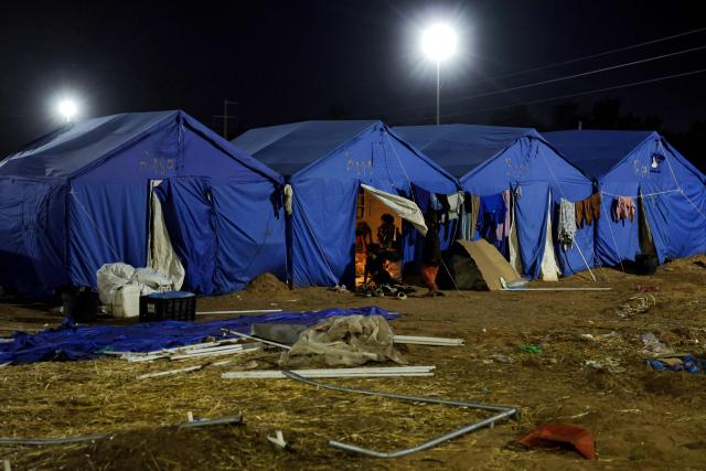 People sit in a tent shelter at a relief camp for those affected by floods that struck northern and western Morocco, in the Kenitra region on February 20, 2026. (Photo by Abdel Majid BZIOUAT / AFP)