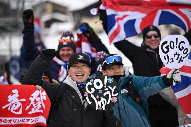 Japanese fans cheer ahead of the freestyle skiing men's ski cross seeding during the Milano Cortina 2026 Winter Olympic Games at Livigno Snow Park, in Livigno (Valtellina), on February 21, 2026. (Photo by Kirill KUDRYAVTSEV / AFP)