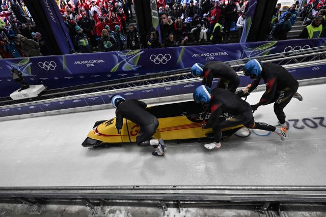 Germany's Francesco Friedrich, Germany's Matthias Sommer, Germany's Alexander Schueller and Germany's Felix Straub compete in  the bobsleigh men's 4-man heat 1 at Cortina Sliding Centre during the Milano Cortina 2026 Winter Olympic Games in Cortina d'Ampezzo on February 21, 2026. (Photo by Tiziana FABI / AFP)