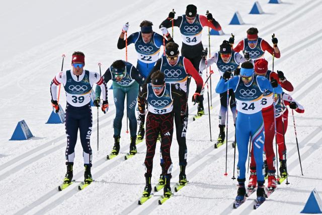 (From L, front) USA's Hunter Wonders, Germany's Jakob Elias Moch and Italy's Simone Dapra compete during the men's cross country 50km mass start final event of the Milano Cortina 2026 Winter Olympic Games at Tesero Cross-Country Skiing Stadium in Lago di Tesero (Val di Fiemme) on February 21, 2026. (Photo by Javier SORIANO / AFP)