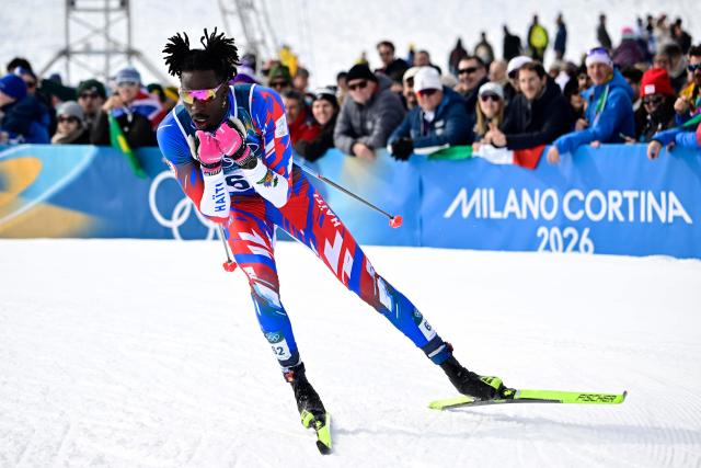 Haiti's Stevenson Savart competes during the men's cross country 50km mass start final event of the Milano Cortina 2026 Winter Olympic Games at Tesero Cross-Country Skiing Stadium in Lago di Tesero (Val di Fiemme) on February 21, 2026. (Photo by Tobias SCHWARZ / AFP)