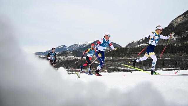 (From R) Sweden's Gustaf Berglund, USA's Gus Schumacher, Canada's Antoine Cyr and Germany's Florian Notz compete during the men's cross country 50km mass start final event of the Milano Cortina 2026 Winter Olympic Games at Tesero Cross-Country Skiing Stadium in Lago di Tesero (Val di Fiemme) on February 21, 2026. (Photo by Tobias SCHWARZ / AFP)