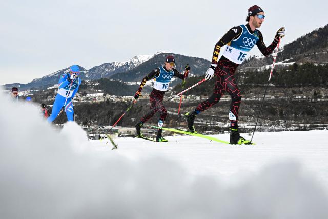 (From R) Germany's Florian Notz, Germany's Friedrich Moch and Italy's Elia Barp compete during the men's cross country 50km mass start final event of the Milano Cortina 2026 Winter Olympic Games at Tesero Cross-Country Skiing Stadium in Lago di Tesero (Val di Fiemme) on February 21, 2026. (Photo by Tobias SCHWARZ / AFP)