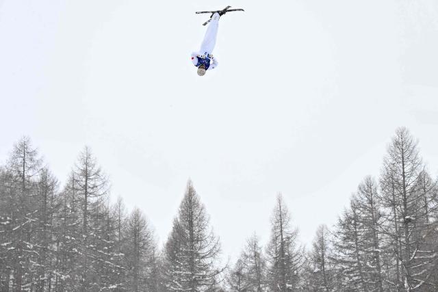 China's Wang Xindi competes in the freestyle skiing mixed team aerials final 2 during the Milano Cortina 2026 Winter Olympic Games at Livigno Aerials & Moguls Park, in Livigno (Valtellina), on February 21, 2026. (Photo by Jeff PACHOUD / AFP)