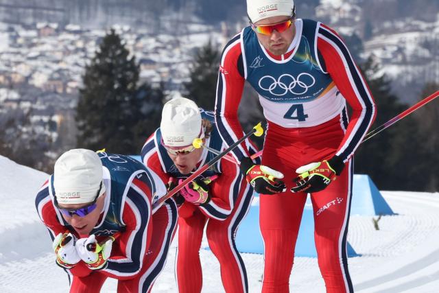 (From L) Norway's Martin Loewstroem Nyenget, Norway's Johannes Hoesflot Klaebo and Norway's Emil Iversen compete during the men's cross country 50km mass start final event of the Milano Cortina 2026 Winter Olympic Games at Tesero Cross-Country Skiing Stadium in Lago di Tesero (Val di Fiemme) on February 21, 2026. (Photo by Anne-Christine POUJOULAT / AFP)
