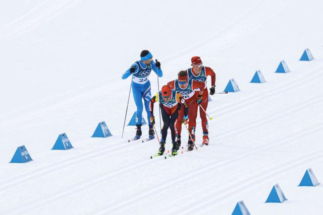 (From L) Italy's Simone Dapra, Canada's Thomas Stephen, Switzerland's Beda Klee and Switzerland's Nicola Wigger compete during the men's cross country 50km mass start final event of the Milano Cortina 2026 Winter Olympic Games at Tesero Cross-Country Skiing Stadium in Lago di Tesero (Val di Fiemme) on February 21, 2026. (Photo by Anne-Christine POUJOULAT / AFP)