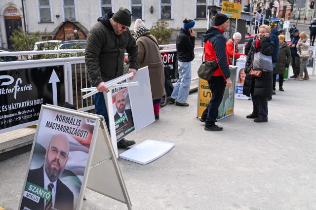 Party activists gather voters’ signatures in central Budapest on February 21, 2026, as the campaign season officially begins in Hungary. Less than two months before the general election, candidates must collect signatures from at least 500 people in their district to run in the April 12, 2026 vote. (Photo by Attila KISBENEDEK / AFP)