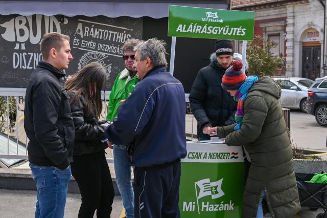 Party activists from the far-right "Our Homeland" party gather voters’ signatures in central Budapest on February 21, 2026, as the campaign season officially begins in Hungary. Less than two months before the general election, candidates must collect signatures from at least 500 people in their district to run in the April 12, 2026 vote. (Photo by Attila KISBENEDEK / AFP)