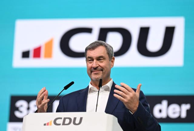 Bavaria's State Premier and leader of the conservative Christian Social Union (CSU) Markus Soeder reacts on stage during the party congress of Germany's Christian Democratic Union (CDU) in Stuttgart, southern Germany, on February 21, 2026. (Photo by THOMAS KIENZLE / AFP)
