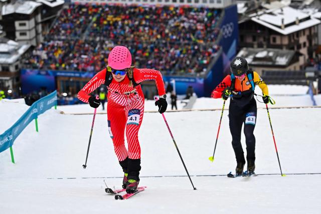 Austria's Johanna Hiemer (L) and Germany's Tatjana Paller competes in the mixed relay ski mountaineering race during the Milano Cortina 2026 Winter Olympic Games at the Stelvio Ski Centre in Bormio (Valtellina) on February 21, 2026. (Photo by Fabrice COFFRINI / AFP)