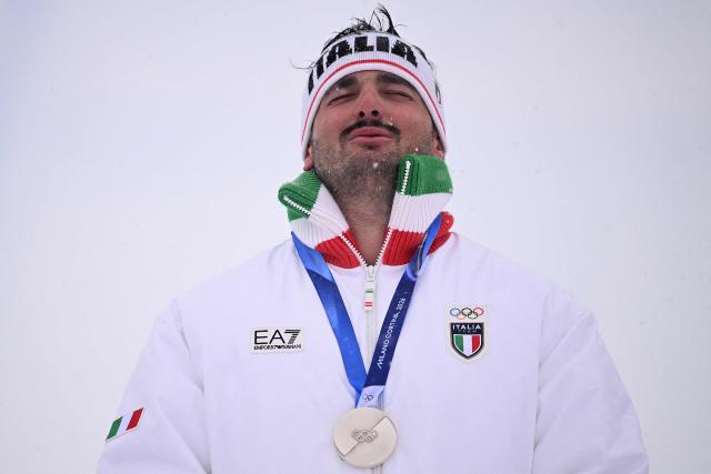 Silver medallist Italy's Federico Tomasoni poses on the podium after the freestyle skiing men's ski cross final during the Milano Cortina 2026 Winter Olympic Games at Livigno Snow Park, in Livigno (Valtellina), on February 21, 2026. (Photo by Kirill KUDRYAVTSEV / AFP)