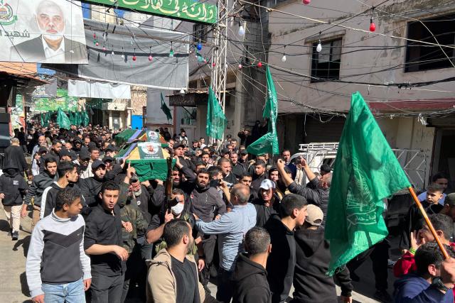 Mourners carry the coffins of two people the day after they were killed in an Israeli strike on the Palestinian refugee camp in Ain al-Hilweh, near the coastal city of Sidon, in southern Lebanon on February 21, 2026. Lebanon's health ministry said 10 people were killed on February 20, 2026, in the east and two in the south of the country both areas where Hezbollah holds sway. The strikes come as tensions are brewing between the United States and Iran, with the US president threatening military action over the Islamic republic's nuclear programme. (Photo by Mahmoud ZAYYAT / AFP)