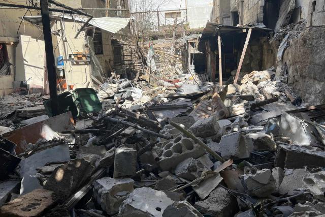Rubble and debris of a building litters the ground the day after an  Israeli strike on the Palestinian refugee camp in Ain al-Hilweh, near the coastal city of Sidon, in southern Lebanon on February 21, 2026. Lebanon's health ministry said 10 people were killed on February 20, 2026, in the east and two in the south of the country both areas where Hezbollah holds sway. The strikes come as tensions are brewing between the United States and Iran, with the US president threatening military action over the Islamic republic's nuclear programme. (Photo by Mahmoud ZAYYAT / AFP)