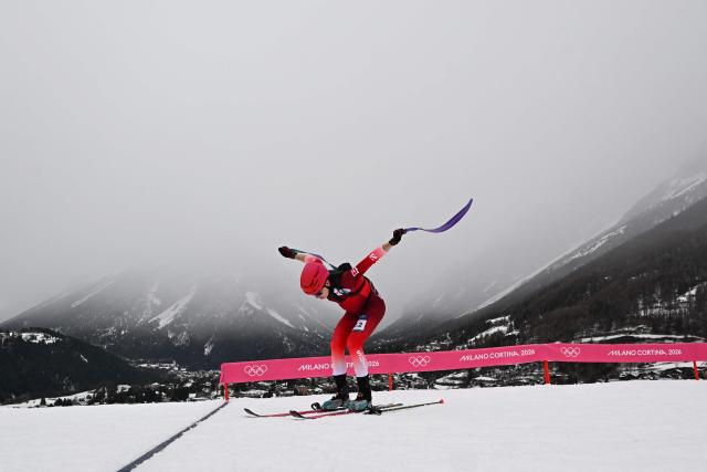 TOPSHOT - Switzerland's Jon Kistler takes off the climbing skin as he competes in the mixed relay ski mountaineering race during the Milano Cortina 2026 Winter Olympic Games at the Stelvio Ski Centre in Bormio (Valtellina) on February 21, 2026. (Photo by Fabrice COFFRINI / AFP)