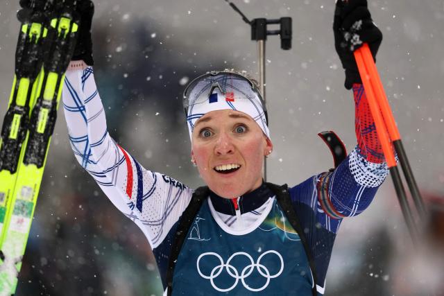 France's Oceane Michelon celebrates after winning gold in the women's biathlon 12.5km mass start event during the Milano Cortina 2026 Winter Olympic Games at the Anterselva Biathlon Arena (Sudtirol Arena) in Anterselva (Val Pusteria) on February 21, 2026. (Photo by FRANCK FIFE / AFP)