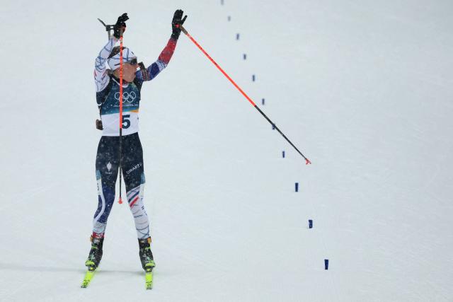 France's Oceane Michelon reacts as she approaches the finish line during the women's biathlon 12.5km mass start event during the Milano Cortina 2026 Winter Olympic Games at the Anterselva Biathlon Arena (Sudtirol Arena) in Anterselva (Val Pusteria) on February 21, 2026. (Photo by Odd ANDERSEN / AFP)
