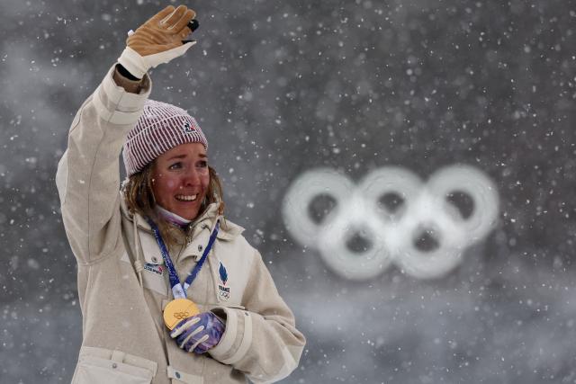 Gold medallist France's Oceane Michelon poses on the podium of the women's biathlon 12.5km mass start event during the Milano Cortina 2026 Winter Olympic Games at the Anterselva Biathlon Arena (Sudtirol Arena) in Anterselva (Val Pusteria) on February 21, 2026. (Photo by FRANCK FIFE / AFP)