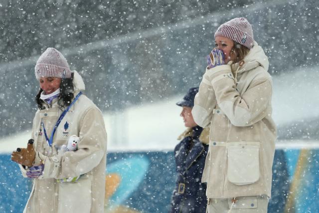 Silver medallist France's Julia Simon (L) and gold medallist France's Oceane Michelon stand on the podium of the women's biathlon 12.5km mass start event during the Milano Cortina 2026 Winter Olympic Games at the Anterselva Biathlon Arena (Sudtirol Arena) in Anterselva (Val Pusteria) on February 21, 2026. (Photo by Odd ANDERSEN / AFP)