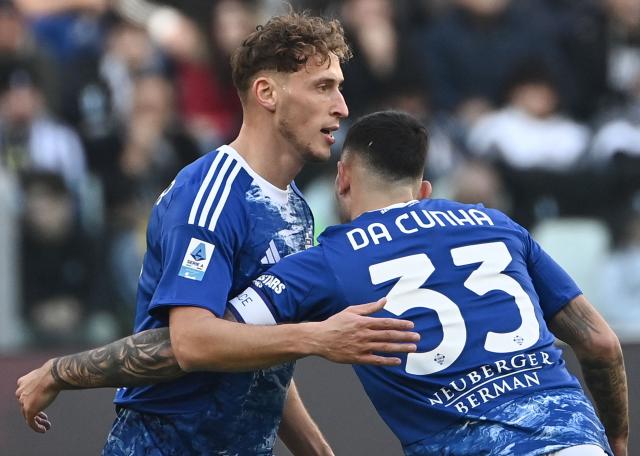 Como's Kosovar defender #31 Mergim Vojvoda is congratulated after scoring his team's first goal during the Italian Serie A football match between Juventus and Como at the Allianz stadium in Turin on February 21, 2026. (Photo by Isabella BONOTTO / AFP)
