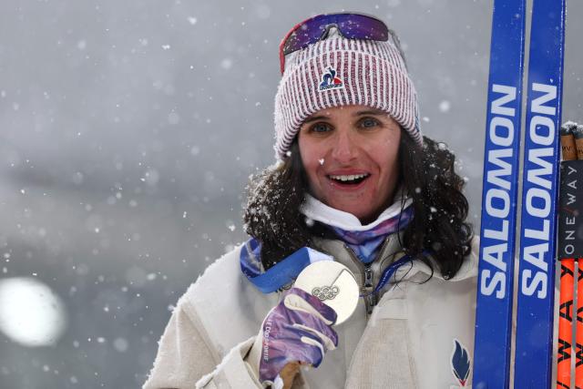 Silver medallist France's Julia Simon poses on the podium of the women's biathlon 12.5km mass start event during the Milano Cortina 2026 Winter Olympic Games at the Anterselva Biathlon Arena (Sudtirol Arena) in Anterselva (Val Pusteria) on February 21, 2026. (Photo by FRANCK FIFE / AFP)