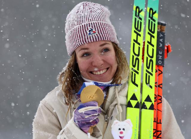 Gold medallist France's Oceane Michelon poses on the podium of the women's biathlon 12.5km mass start event during the Milano Cortina 2026 Winter Olympic Games at the Anterselva Biathlon Arena (Sudtirol Arena) in Anterselva (Val Pusteria) on February 21, 2026. (Photo by FRANCK FIFE / AFP)