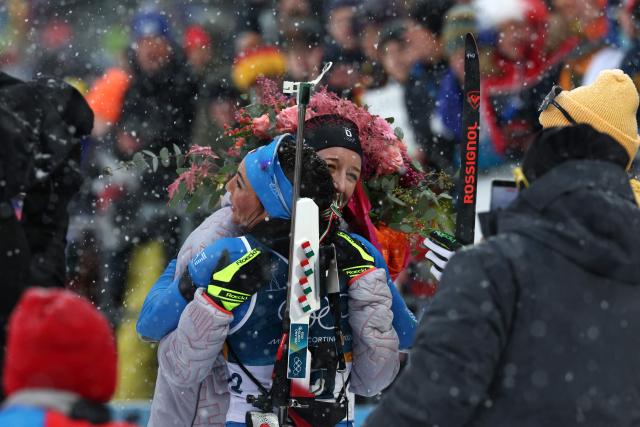 Germany's Franziska Preuss (R) and Italy's Dorothea Wierer hug after competing in the women's biathlon 12.5km mass start event during the Milano Cortina 2026 Winter Olympic Games at the Anterselva Biathlon Arena (Sudtirol Arena) in Anterselva (Val Pusteria) on February 21, 2026. (Photo by FRANCK FIFE / AFP)