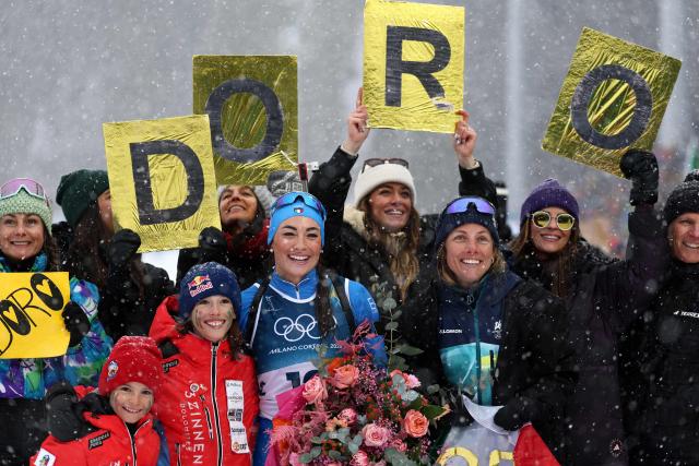 Italy's Dorothea Wierer (C) poses after competing in the women's biathlon 12.5km mass start event during the Milano Cortina 2026 Winter Olympic Games at the Anterselva Biathlon Arena (Sudtirol Arena) in Anterselva (Val Pusteria) on February 21, 2026. (Photo by FRANCK FIFE / AFP)