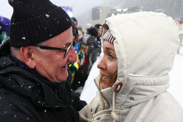 Gold medallist France's Oceane Michelon (R) celebrates with supporters after the victory ceremony of the women's biathlon 12.5km mass start event during the Milano Cortina 2026 Winter Olympic Games at the Anterselva Biathlon Arena (Sudtirol Arena) in Anterselva (Val Pusteria) on February 21, 2026. (Photo by Franck FIFE / AFP)