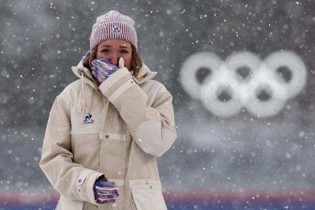 Gold medallist France's Oceane Michelon reacts on the podium of the women's biathlon 12.5km mass start event during the Milano Cortina 2026 Winter Olympic Games at the Anterselva Biathlon Arena (Sudtirol Arena) in Anterselva (Val Pusteria) on February 21, 2026. (Photo by FRANCK FIFE / AFP)