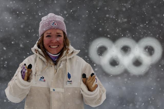 Gold medallist France's Oceane Michelon reacts on the podium of the women's biathlon 12.5km mass start event during the Milano Cortina 2026 Winter Olympic Games at the Anterselva Biathlon Arena (Sudtirol Arena) in Anterselva (Val Pusteria) on February 21, 2026. (Photo by FRANCK FIFE / AFP)