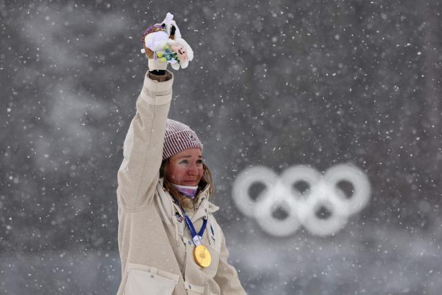 Gold medallist France's Oceane Michelon poses on the podium of the women's biathlon 12.5km mass start event during the Milano Cortina 2026 Winter Olympic Games at the Anterselva Biathlon Arena (Sudtirol Arena) in Anterselva (Val Pusteria) on February 21, 2026. (Photo by FRANCK FIFE / AFP)