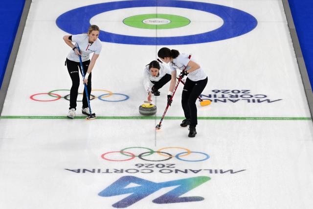 (From L) USA's Taylor Anderson-Heide, USA's Tabitha Peterson and USA's Tara Peterson compete in the curling women's round robin bronze medal game between Canada and USA during the Milano Cortina 2026 Winter Olympic Games at the Cortina Curling Olympic Stadium in Cortina d’Ampezzo on February 21, 2026. (Photo by Antonin THUILLIER / AFP)